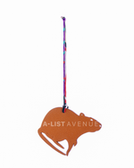Hermes Petit H Rat bag charm crafted from orange leather.