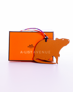 Hermes Petit H Rat bag charm crafted from orange leather.